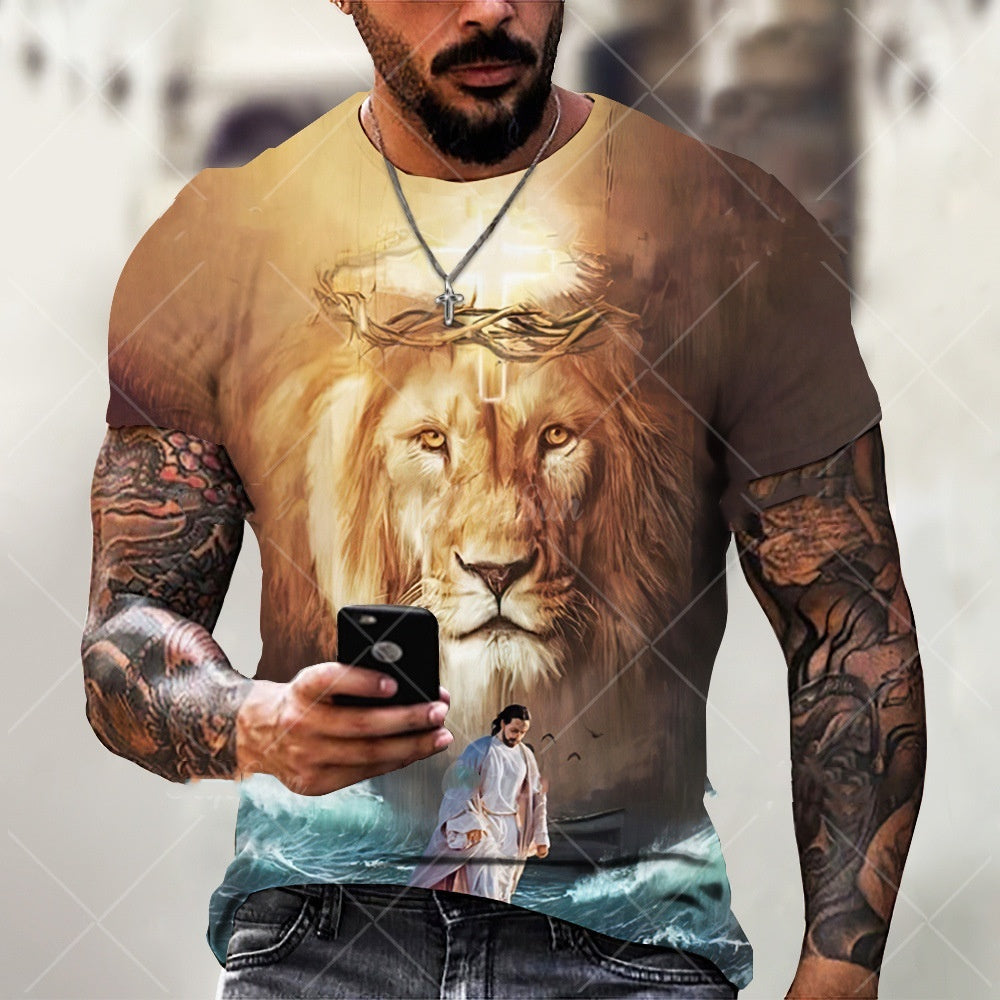 Man wearing a t-shirt with a lion design and tattoos holding a phone.