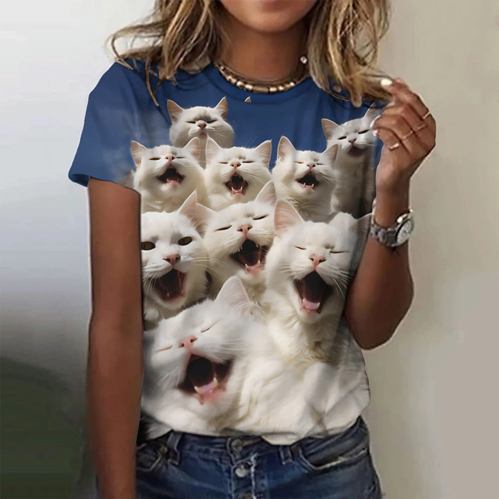 Person wearing a blue t-shirt with a graphic of white cats