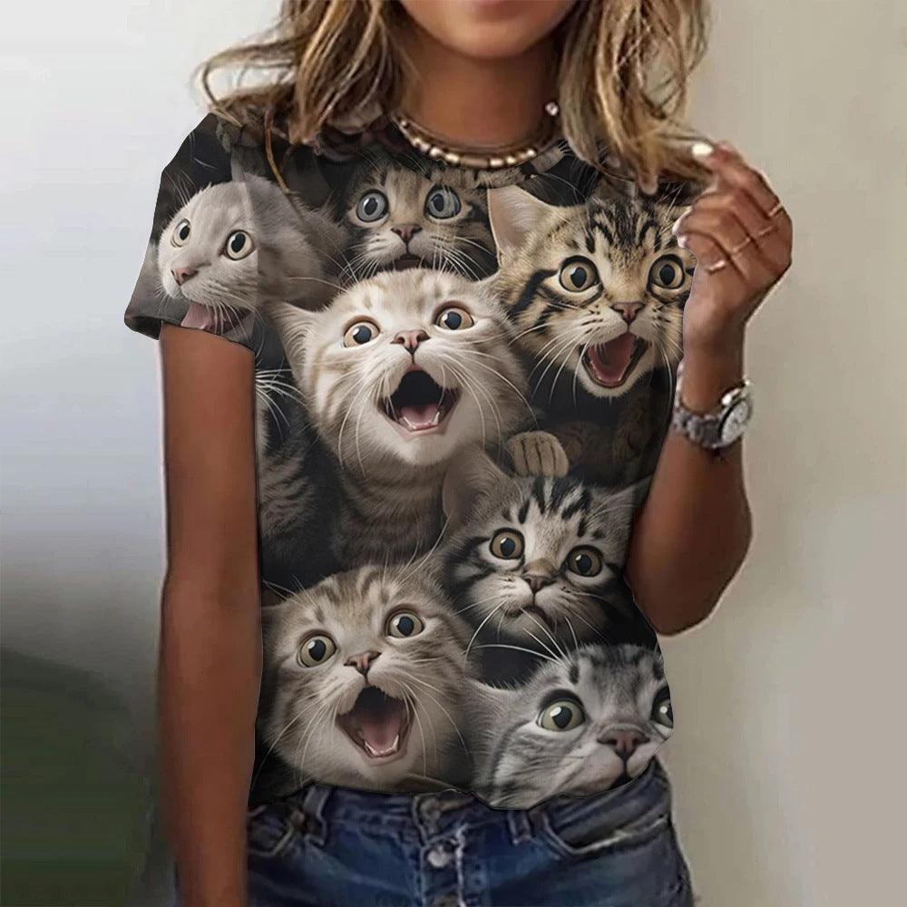 Person wearing a t-shirt with a graphic of various cats' faces.