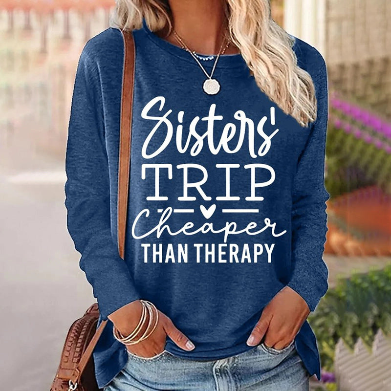 Person wearing a blue sweatshirt with 'Sisters' Trip Cheaper Than Therapy' text.