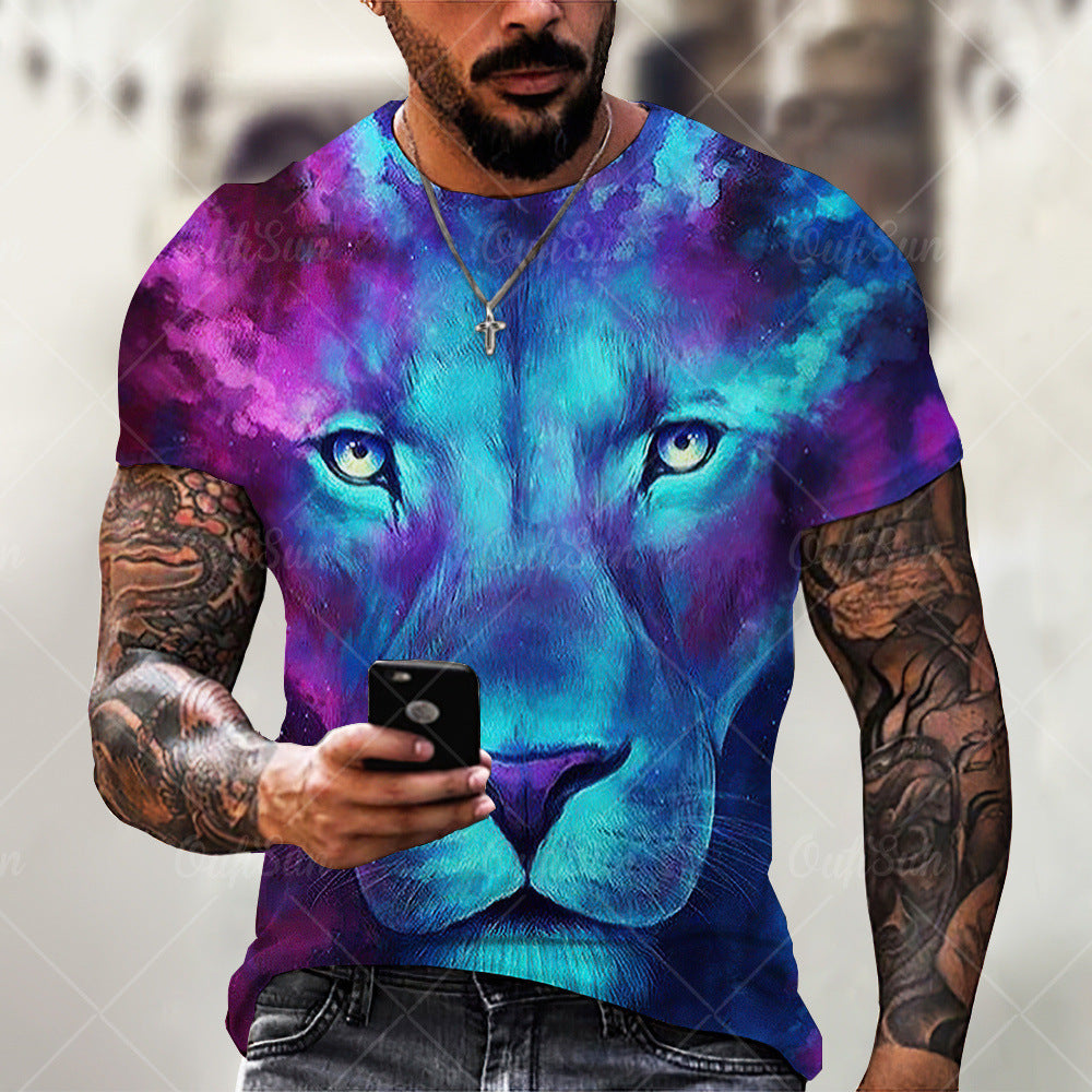 Person wearing a colorful lion t-shirt with tattoos holding a phone.