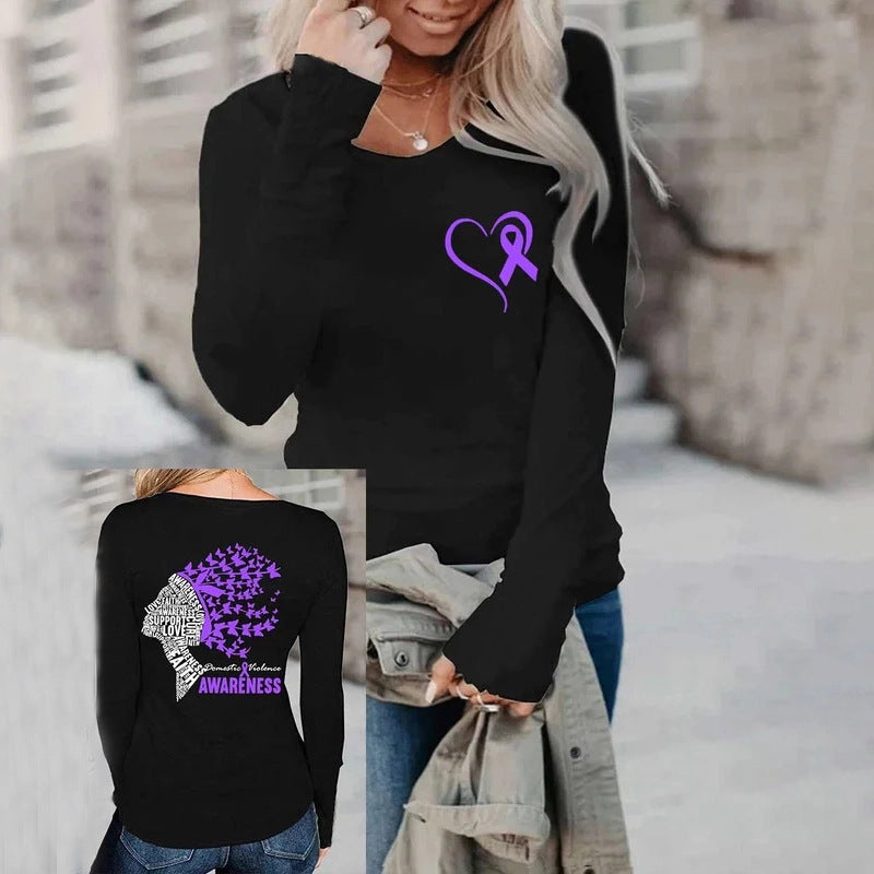 Black sweatshirt with purple heart and butterfly design worn by a person outdoors.