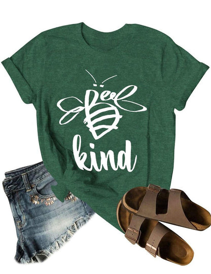 Green t-shirt with 'Be kind' bee design, denim shorts, and brown sandals on a white background
